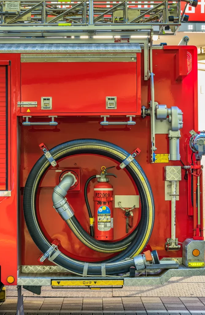 rear view red japanese fire truck equipped with coiled fire hose fire tank